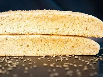 Two pieces of bread with sesame seeds on top.