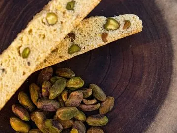 A plate of food with two pieces of bread and nuts.