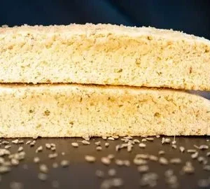 Two pieces of bread with sesame seeds on top.