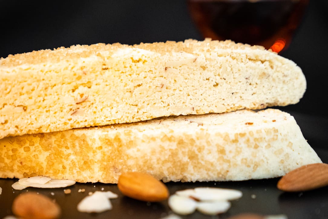 G. G. Biscotti Co. artisan Almond biscotti close up with whole and sliced almonds in the foreground